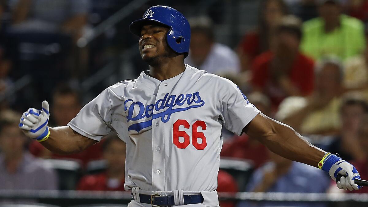 Dodgers outfielder Yasiel Puig reacts after striking out against the Atlanta Braves on Aug. 13.