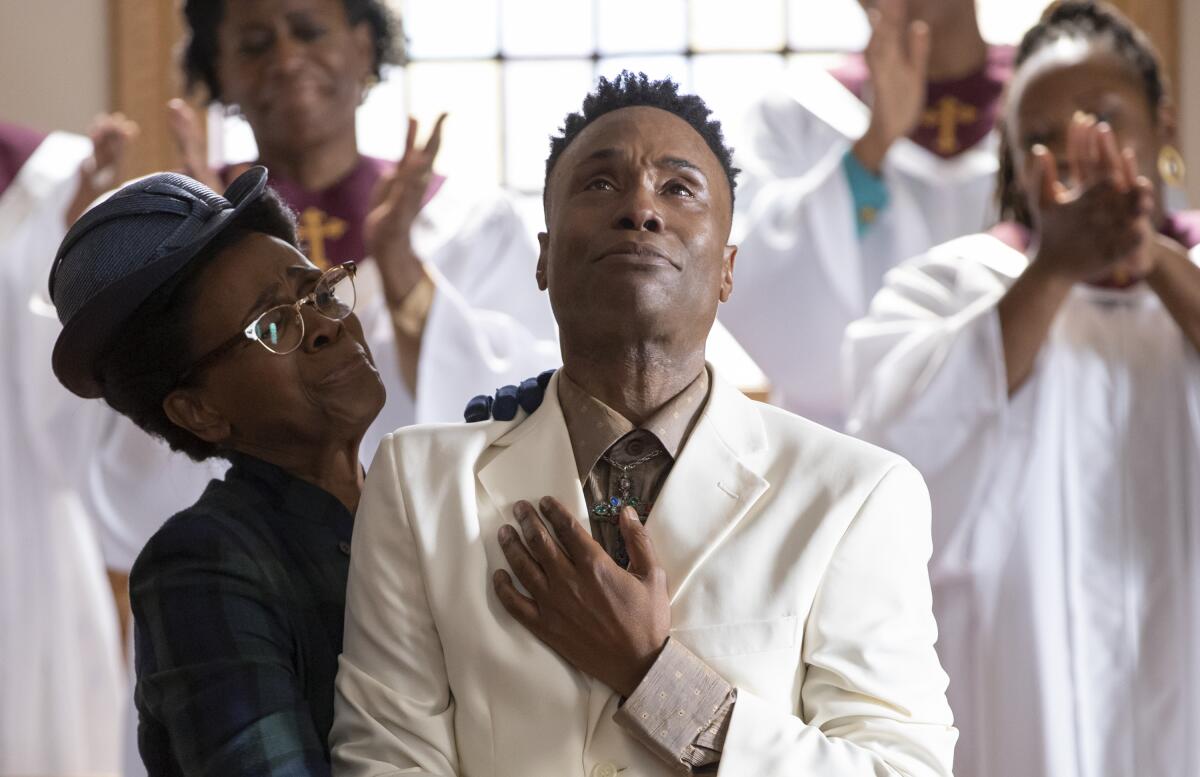 A man in a white suit surrounded by a choir