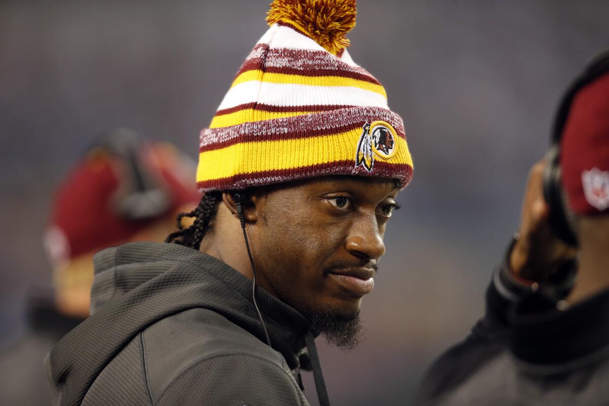 Washington Redskins quarterback Robert Griffin III watches from the sideline against the Dallas Cowboys in Arlington, Texas, on Oct. 27, 2014.