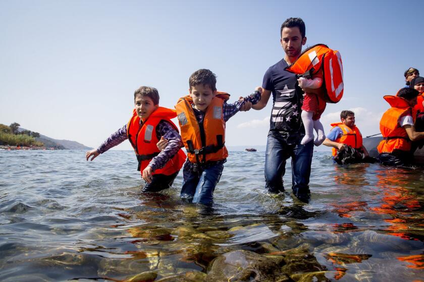 Refugees come ashore Tuesday near the village of Skala Sikamineas on the island of Lesbos in Greece.