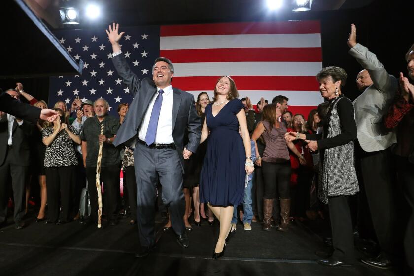 U.S. Rep. Cory Gardner and wife Jaime wave to supporters during a GOP election night gathering in Denver.