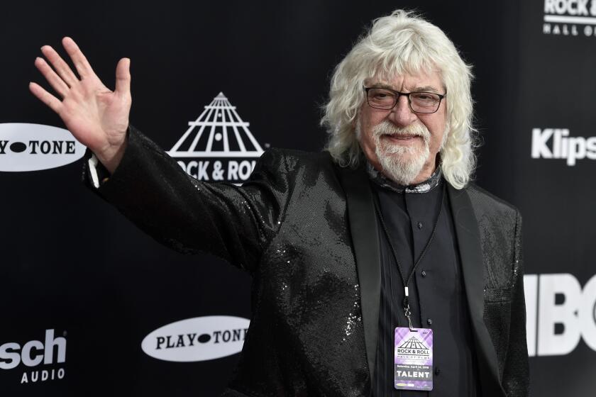 FILE - Graeme Edge, drummer for The Moody Blues, waves on the red carpet before the Rock & Roll Hall of Fame induction ceremony April 14, 2018, in Cleveland. Edge, a drummer and co-founder of the band, has died. He was 80. The band’s frontman, Justin Hayward, confirmed Edge’s death Thursday, Nov. 11, 2021, on the group’s website. The cause of his death has not been revealed. Hayward called Edge the backbone of the British rock band. The band's last album was released in 2003. (AP Photo/David Richard, File)