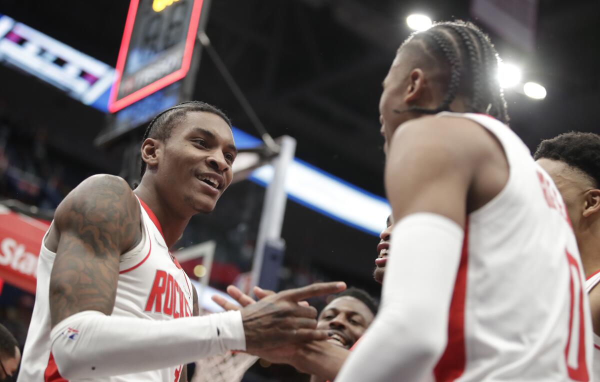 Houston guard Kevin Porter Jr. celebrates with Jalen Green after making a game-winning three-point shot against Washington.