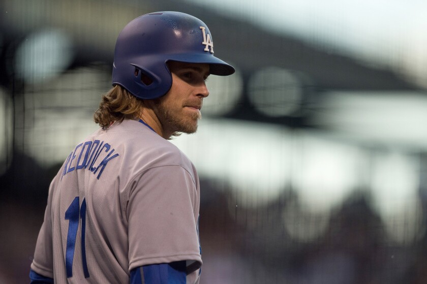 Dodgers outfielder Josh Reddick (11) looks on from the on-deck circle in the first inning.