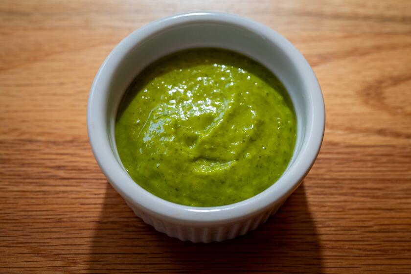 LOS ANGELES, CA - AUGUST 28: A green sauce, made of cilantro, jalapenos, garlic, lime juice, avocado, olive oil and salt and pepper, which goes with a fried pork sandwich, photographed at a Los Angeles, CA, home, Friday, Aug. 28, 2020. (Jay L. Clendenin / Los Angeles Times)