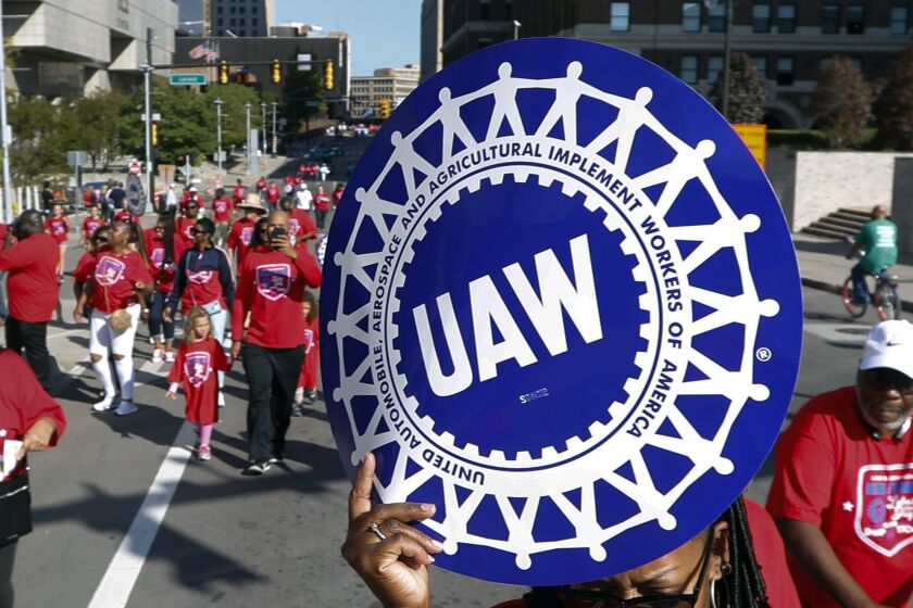 FILE - United Auto Workers members walk in the Labor Day parade in Detroit, Sept. 2, 2019. Members of the United Auto Workers union appeared on Thursday, Dec. 1, 2022, to favor replacing many of their current leaders in an election that stemmed from a federal bribery and embezzlement scandal involving former union officials. (AP Photo/Paul Sancya, File)
