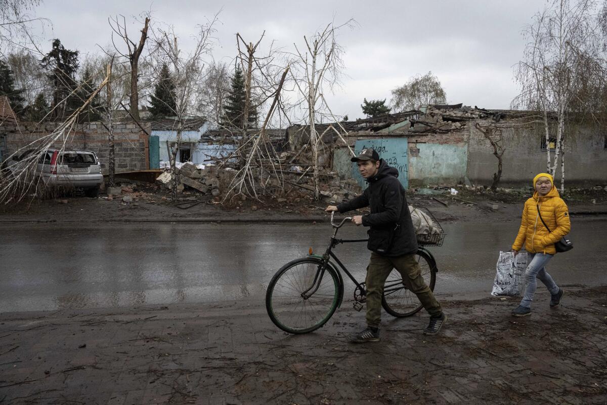 Locals walk past a house that was destroyed during a Russian attack in Kostiantynivka, Ukraine.