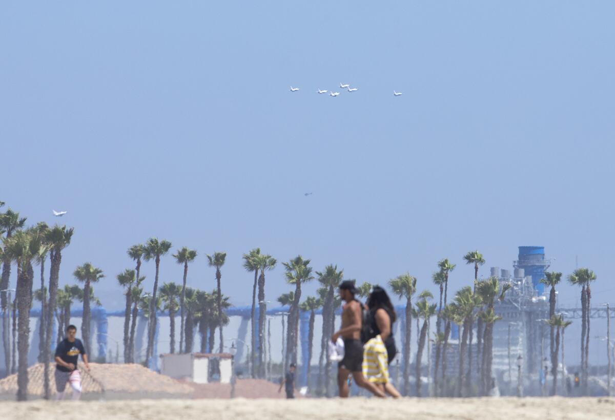 The Thunderbirds fly south over Huntington Beach on Friday.