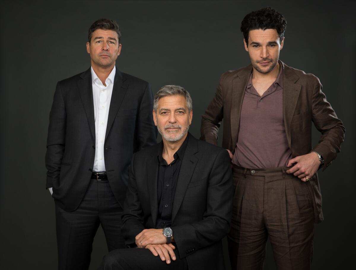 George Clooney, center, with actors Kyle Chandler, left, and Chris Abbott, stars in and directs an adaptation of Joseph Heller's satirical novel "Catch 22" for Hulu. They posed for this portrait at New York's Carlyle Hotel on May 1, 2019.