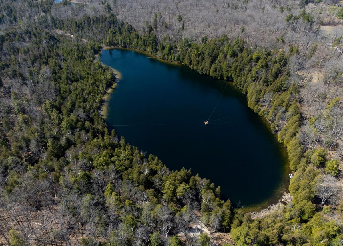 An aerial view of a small blue lake.