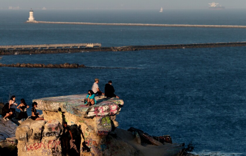 Visitors sit atop house foundations at Sunken City, overlooking the Pacific Ocean in San Pedro.
