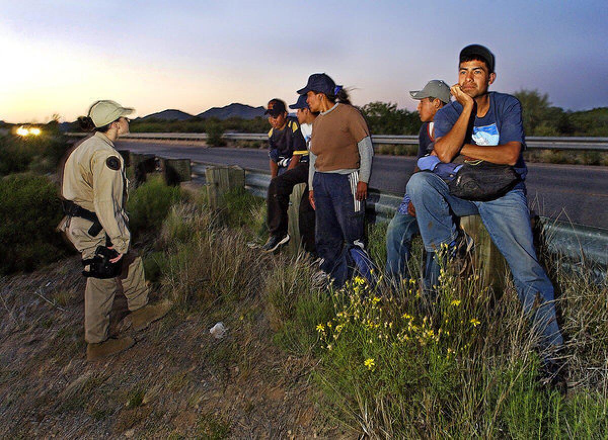 Border Patrol agents speak to men who attempted to enter the U.S. in Arizona. The state's law denying bail for certain immigrants is upheld by a federal appeals court.