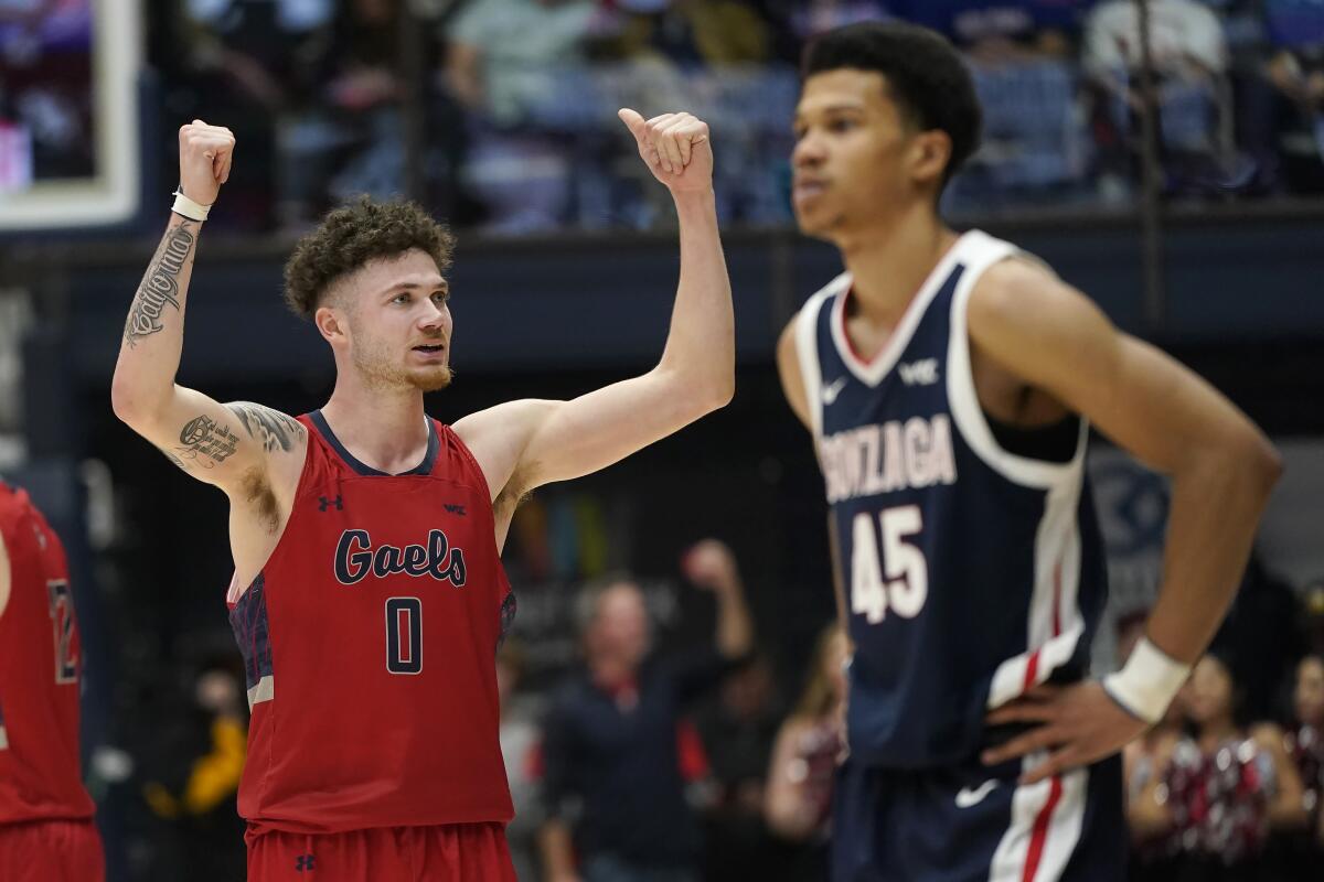 St. Mary's Logan Johnson (0) rejoices near Gonzaga's Rasir Bolton (45) on Saturday night. 