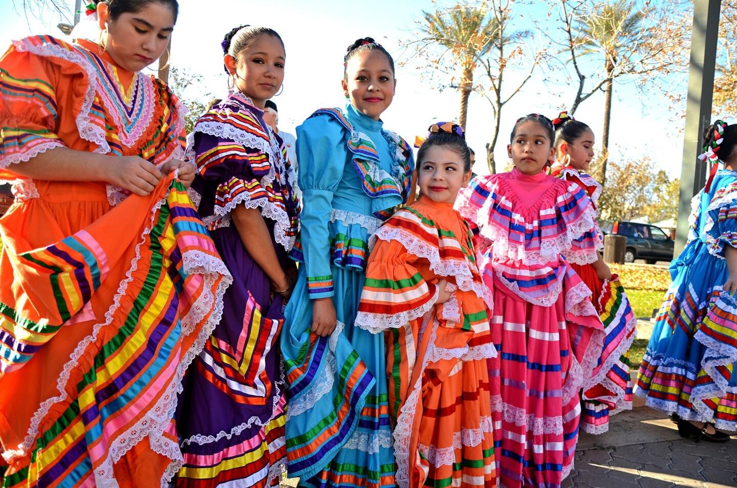 Si Se Puede folkloric dancers prepare to perform at a multicultural festival in the Phoenix suburb of Chandler, Ariz.