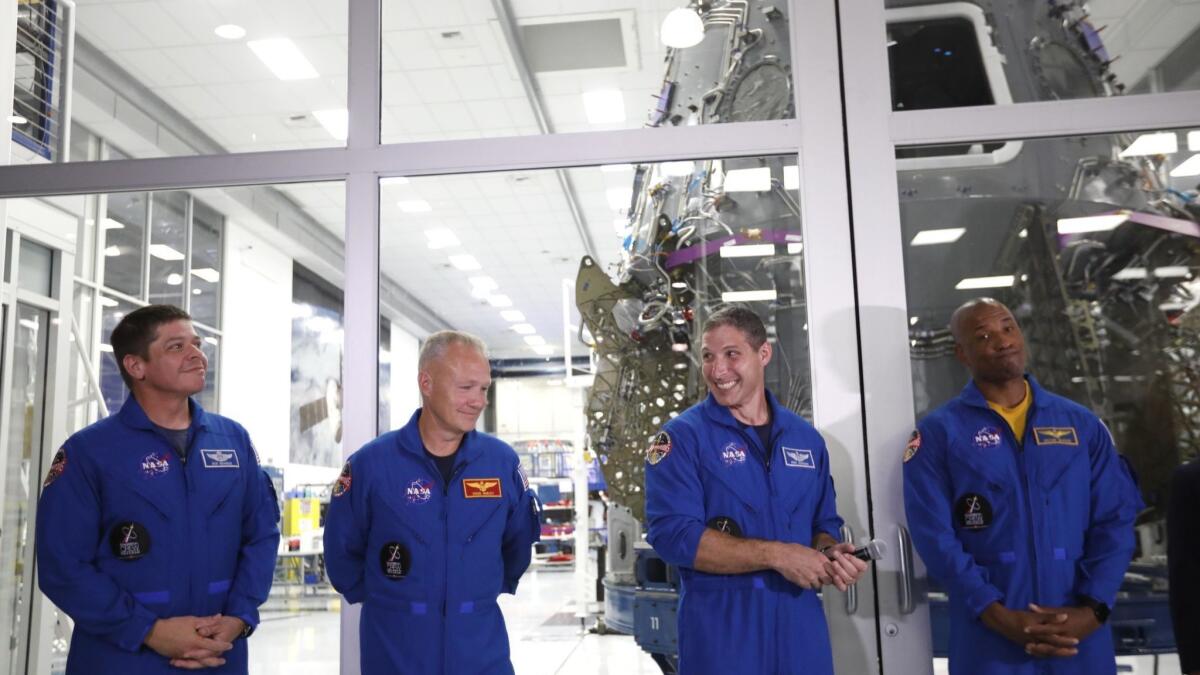 NASA astronauts Robert Behnken, left, Doug Hurley, Mike Hopkins and Victor Glover at a media event at SpaceX in Hawthorne on Aug. 13. They are assigned to ride a SpaceX capsule to the International Space Station.