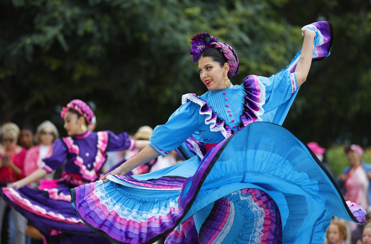 Ximena Soto, right, and Jaslynn Barrientos of DanzArts perform a Mexican folk dance at the Wat
