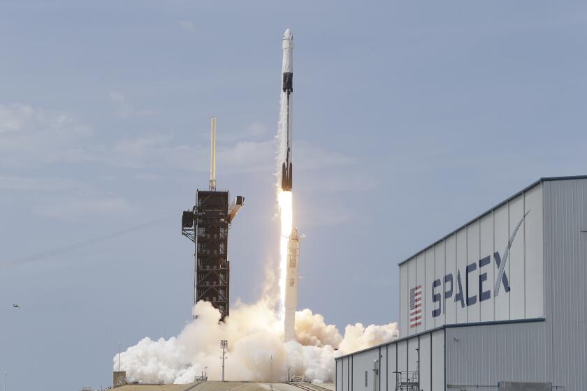 A SpaceX Falcon 9, with NASA astronauts Doug Hurley and Robert Behnken in the Dragon crew capsule, lifts off from Pad 39-A at the Kennedy Space Center in Cape Canaveral, Fla., Saturday, May 30, 2020. The two astronauts are on the SpaceX test flight to the International Space Station. For the first time in nearly a decade, astronauts blasted towards orbit aboard an American rocket from American soil, a first for a private company. (AP Photo/John Raoux)