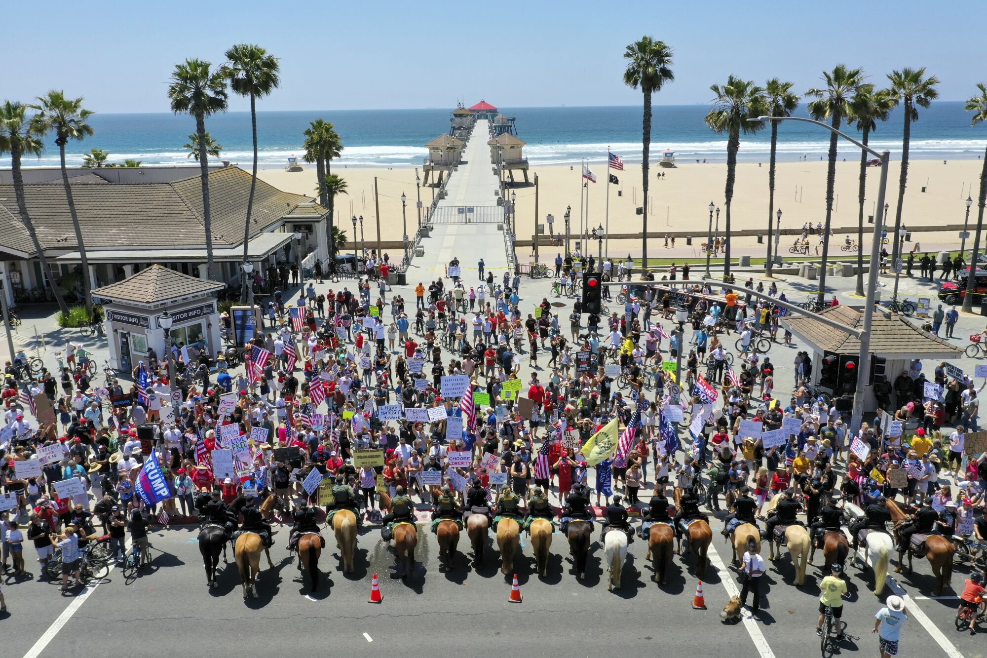Protesters rally at the foot of the Huntington Beach Pier against COVID-related restrictions on May 1. 