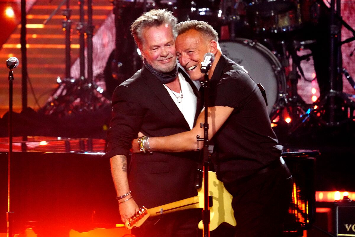 Two men perform on stage.