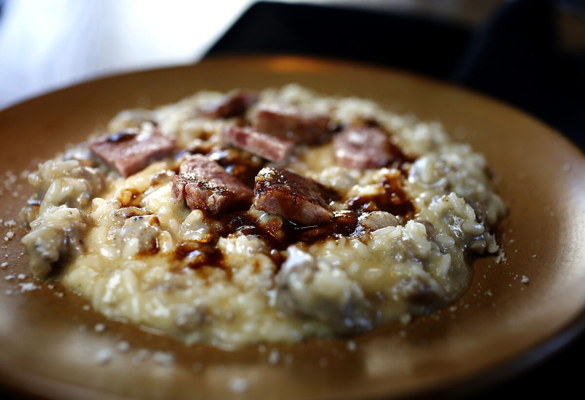 The bassa padana is rice cooked with rope sausage and crumbly cotechino sausage, finished with Grana Padano cheese.