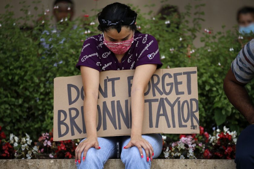 A protester remembering Breonna Taylor listens to a Black Lives Matters rally at City Hall in Dallas on Wednesday, June 3, 2020. Taylor was fatally shot by police officers in Louisville, Ky. (Tom Fox/The Dallas Morning News via AP)