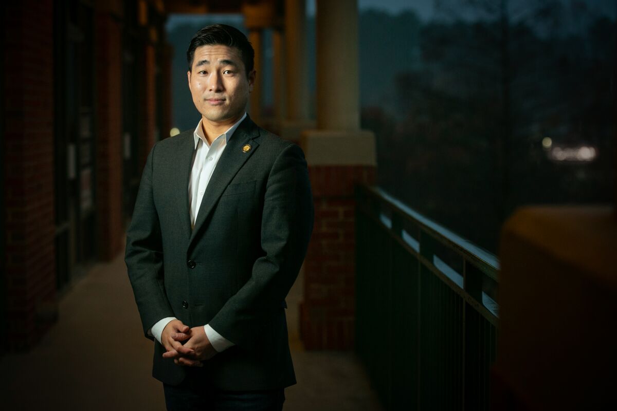 Georgia State Rep. Sam Park poses with hands clasped in front of him outside a Duluth, Ga., shopping center.