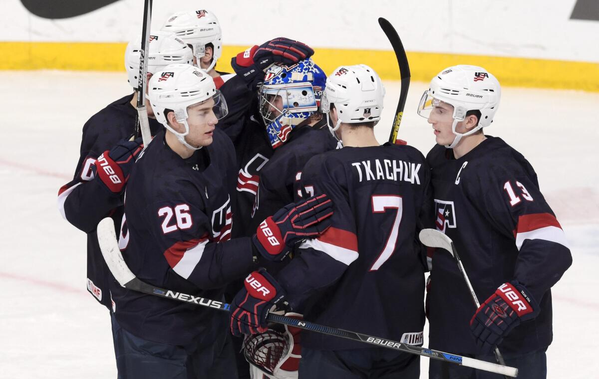 Members of the U.S. team celebrate after their 8-3 victory over Sweden in the bronze medal match of the IIHF World Junior Ice Hockey Championship on Jan. 5.