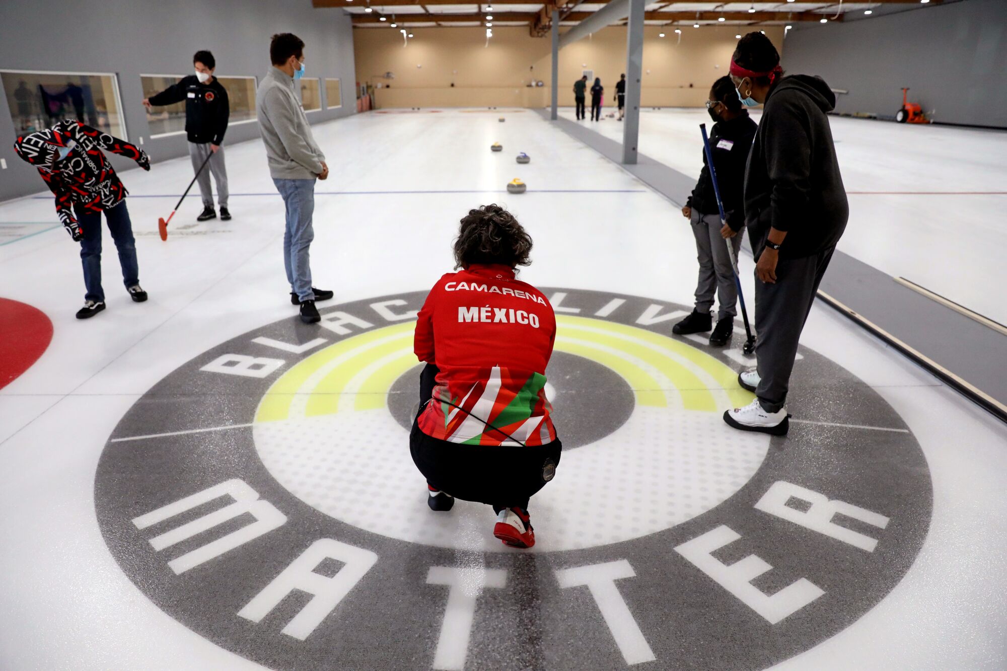 Instructor Adriana Camarena, 51, center, of San Francisco, who is a member of the Mexican curling team.