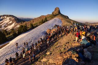 Spectators cheer as runners top the escarpment climbing out of Olympic Valley during the Western States 100