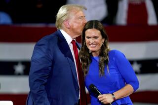 Republican presidential candidate former President Donald Trump, left, on stage with Arkansas Gov. Sarah Huckabee Sanders