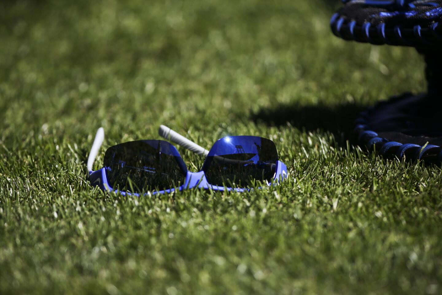 Anthony Rizzo's glasses sit on the grass during practice at Sloan Park on Sunday, Feb. 28, 2016, in Mesa, Ariz.