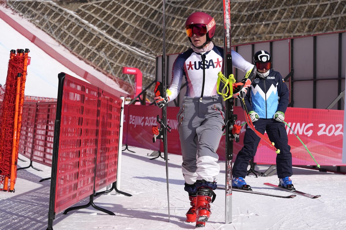 Mikaela Shiffrin of the United States walks through the finish area after a training run at the 2022 Winter Olympics, Thursday, Feb. 10, 2022, in the Yanqing district of Beijing. Two-time Olympic champion and pre-games medal favorite, Mikaela Shiffrin has skied out in the first run of both the slalom and giant slalom. (AP Photo/Luca Bruno)