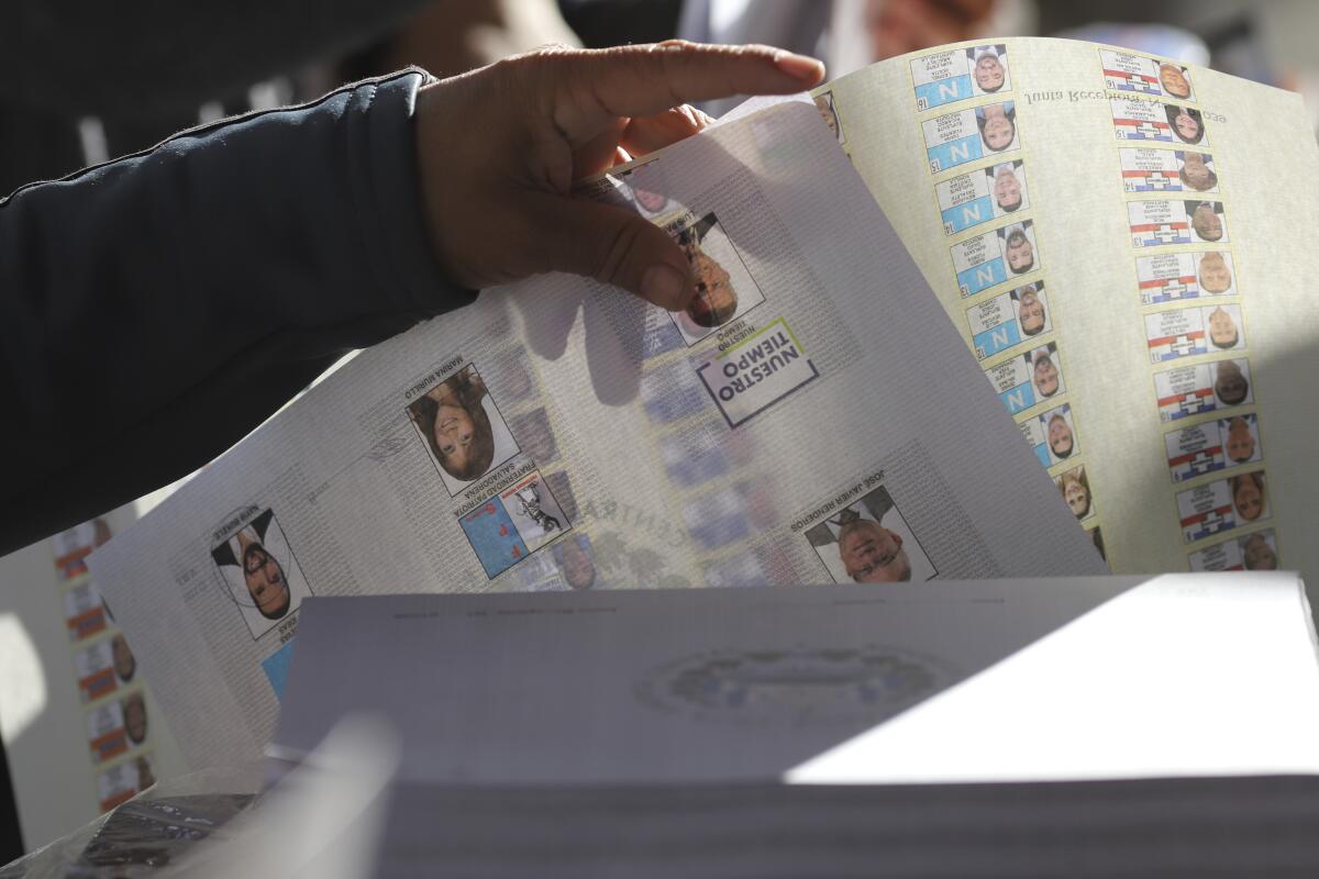 Un votante elige la papeleta de votación durante las elecciones generales en San Salvador, El Salvador, 