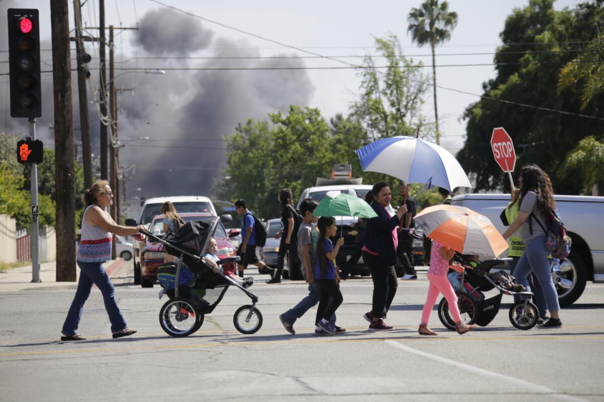 A fire started in a recycling yard in Montclair, then spread to homes and charred dozens of vehicles Monday afternoon.
