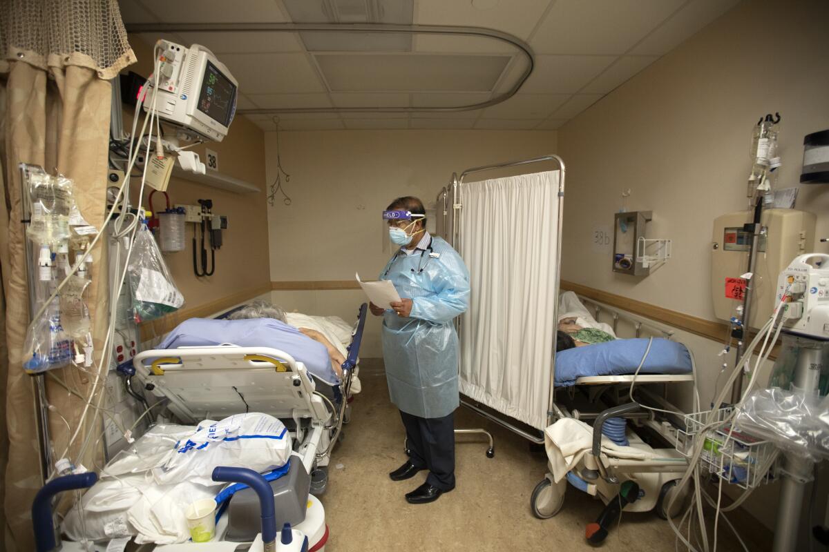 Dr. Bipinchandra Bhagat checks on patients Dec. 22 in Apple Valley, Calif.