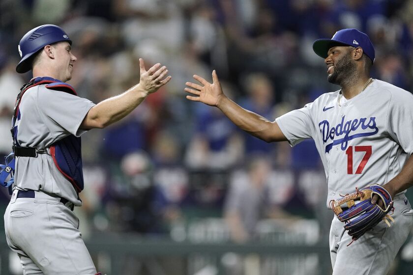 Los Angeles Dodgers second baseman Hanser Alberto (17) and catcher Will Smith celebrate.