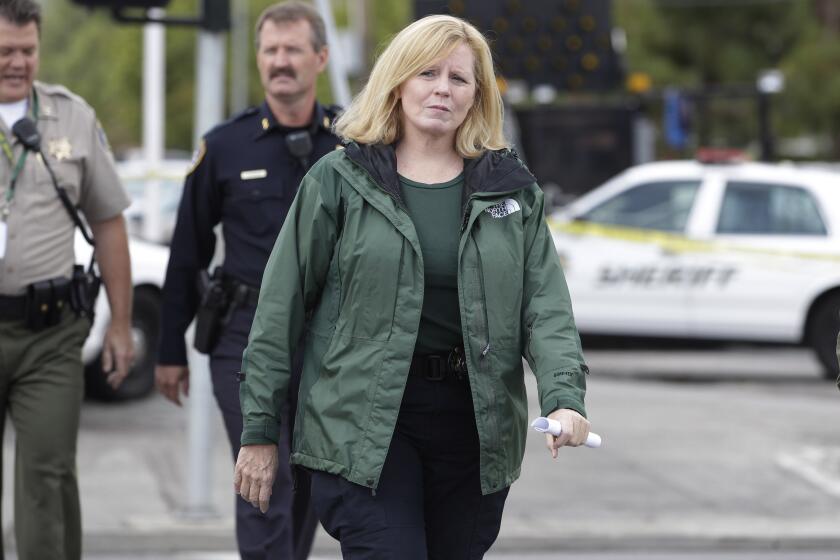FILE - Santa Clara County Sheriff Laurie Smith walks to a news conference in Cupertino, Calif., Wednesday, Oct. 5, 2011. A former manager for a security company who implicated a Santa Clara County Sheriff's captain and others in an alleged bribery scheme to trade political donations supporting the sheriff in exchange for concealed-carry weapons has testified in the civil corruption trial against her. Smith has not been directly implicated in the two criminal indictments that ensnared her undersheriff and a captain. But if the jury finds just one count to be true, she would be removed from office early.(AP Photo/Paul Sakuma, File)