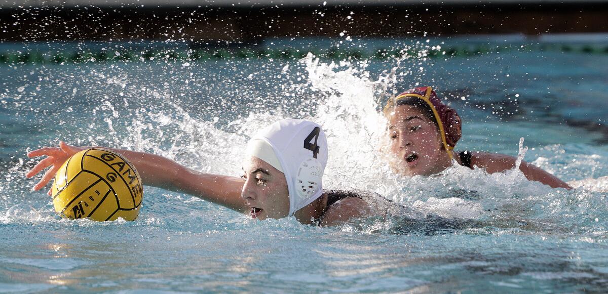 Burbank's Anasheh Abedian keeps the ball under control on a breakaway toward the Arcadia goal in a Pacific League girls' water polo match at Arcadia High School on Thursday, January 9, 2020.