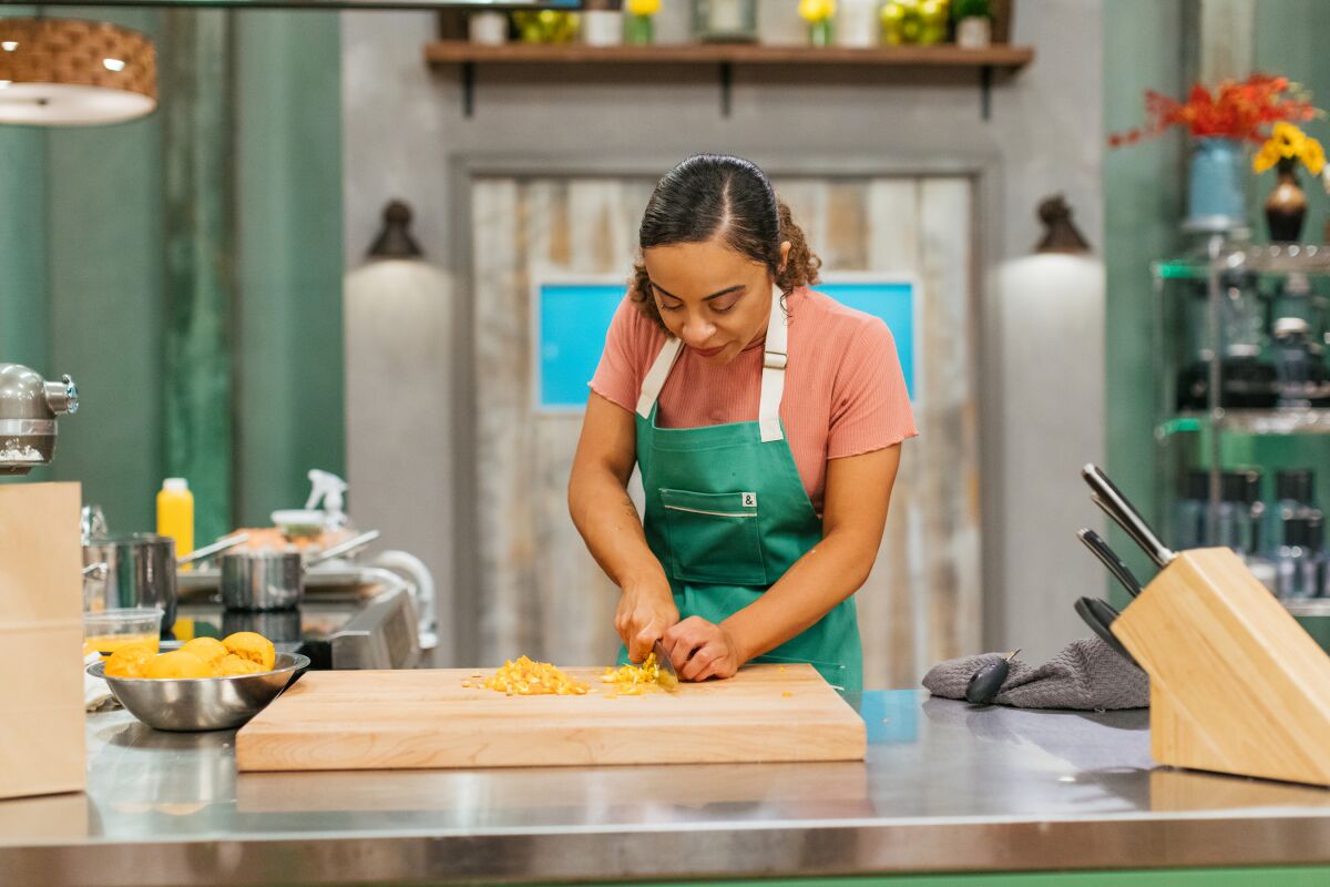 Alexis Wells, 25, of Carlsbad chops ingredients in an episode of Food Network's "Spring Baking Championship."
