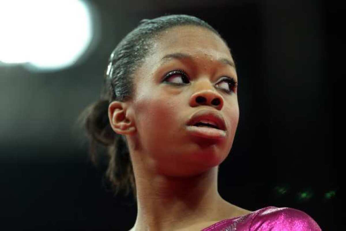 Gabrielle Douglas of the United States looks on before getting on the uneven bars in the Artistic Gymnastics Women's Individual All-Around final on Day 6 of the London 2012 Olympic Games.