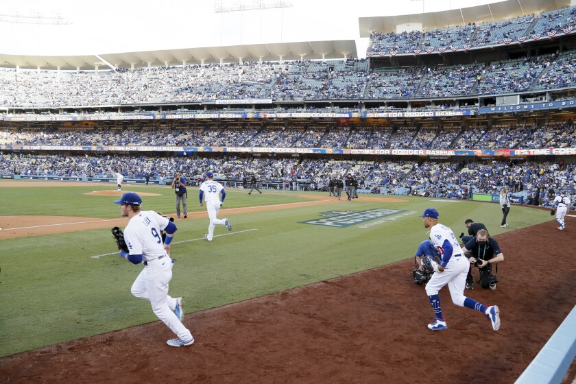 The Dodgers run onto the field at Dodger Stadium