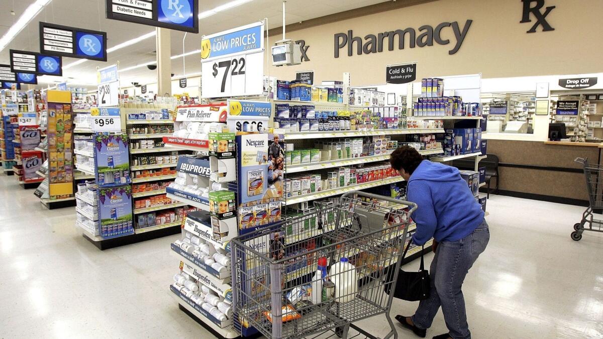 A woman shops in the pharmacy of a Walmart store in Mount Prospect, Ill.