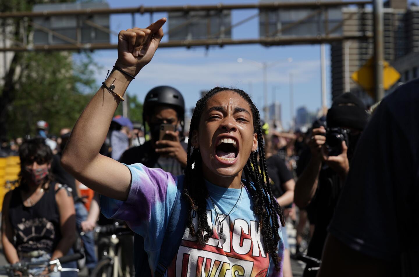 A young protester raises her fist as she crosses the Brooklyn Bridge during a Juneteenth rally in New York.