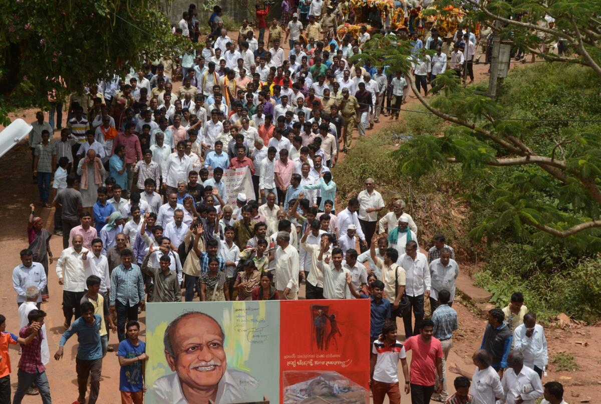 Indian mourners follow the funeral procession for scholar M.M. Kalburgi as his body is taken to be buried at Karnataka University in Dharwad, India, on Aug. 31, 2015.