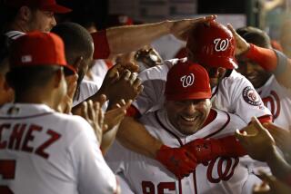 Washington Nationals batting practice pitcher Ali Modami, bottom right, carries Brian Dozier through the dugout after Dozier hit a solo home run in the eighth inning of the team's baseball game against the Philadelphia Phillies, Wednesday, Sept. 25, 2019, in Washington. Washington won 5-2. (AP Photo/Patrick Semansky)