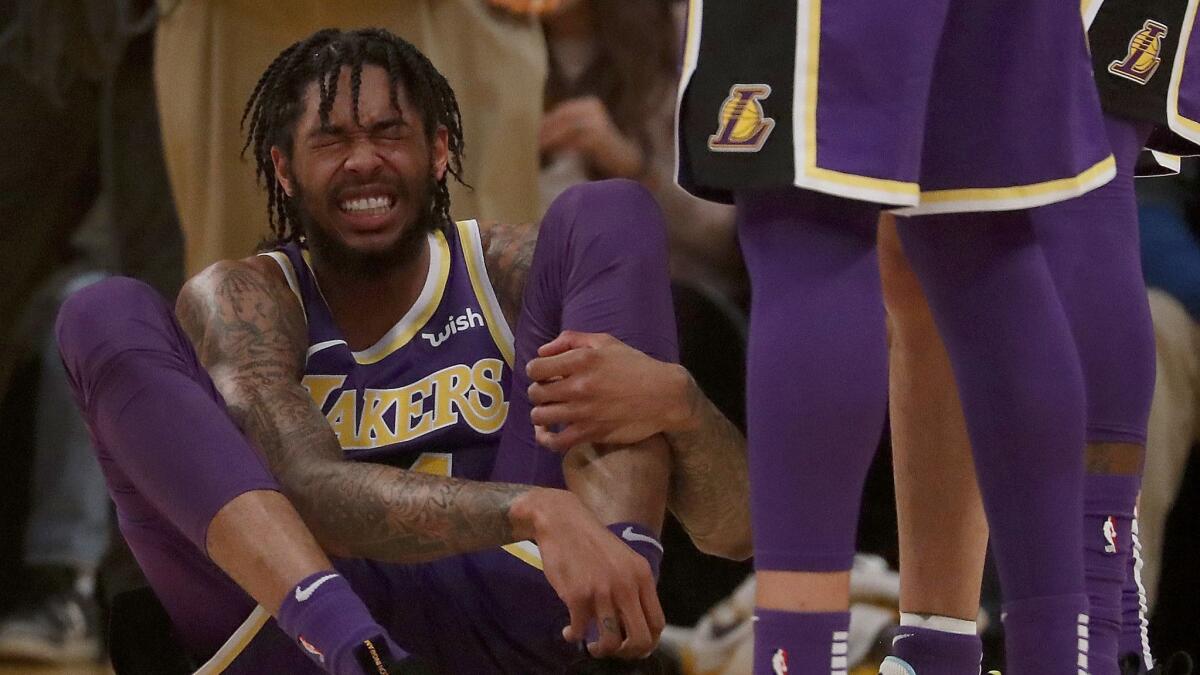 Lakers forward Brandon Ingram winces in pain after being fouled by the Spurs in the first half.