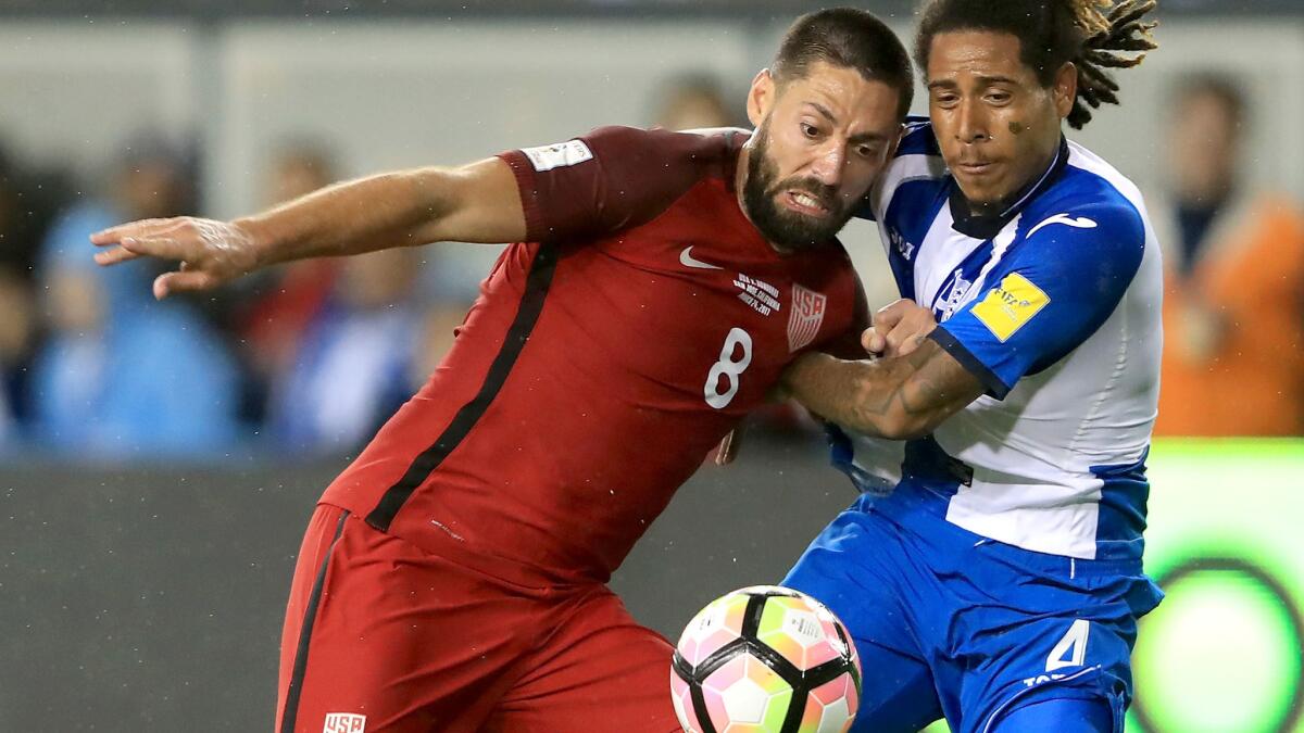 U.S. forward Clint Dempsey (8), who had a hat trick Friday, battles for possession of the ball against Honduras defender Henry Figueroa during the Americans' 6-0 victory in a World Cup qualifier. (Sean M. Haffey / Getty Images)
