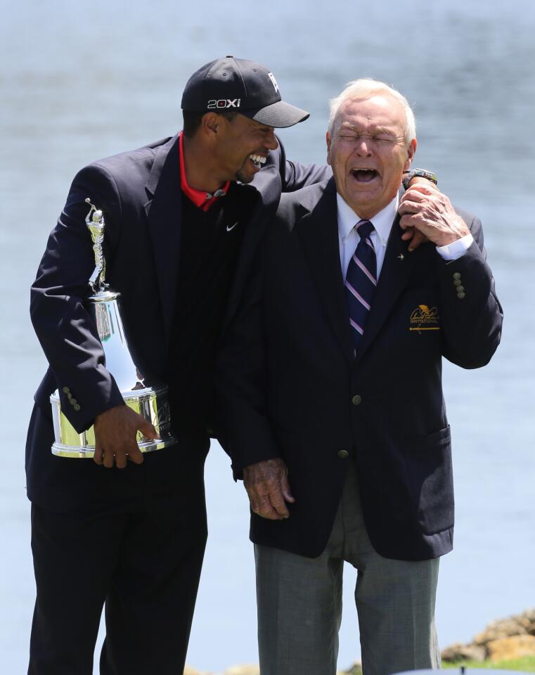 Tiger Woods and Arnold Palmer share a laugh and hug after Woods won his eigth Arnold Palmer Invitational in Orlando, Fla. Monday, March 25, 2013. (Gary W. Green/Orlando Sentinel)