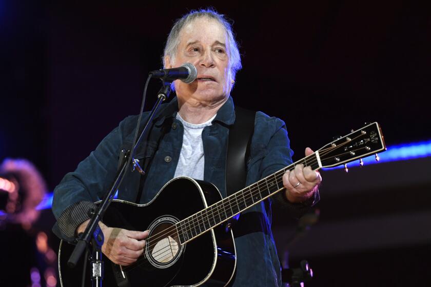 FILE - Paul Simon performs at Global Citizen Live in Central Park in New York on Sept. 25, 2021. Simon will sing for guests at Wednesday's White House state dinner for Japan. The White House says he's one of first lady Jill Biden's favorite musicians. (Photo by Evan Agostini/Invision/AP, File)
