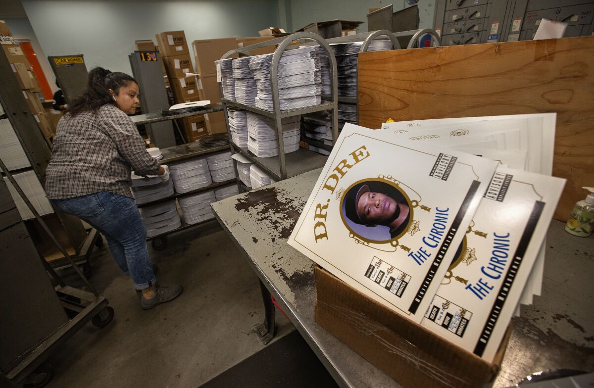 Maria Amador prepares to place records into their album covers.